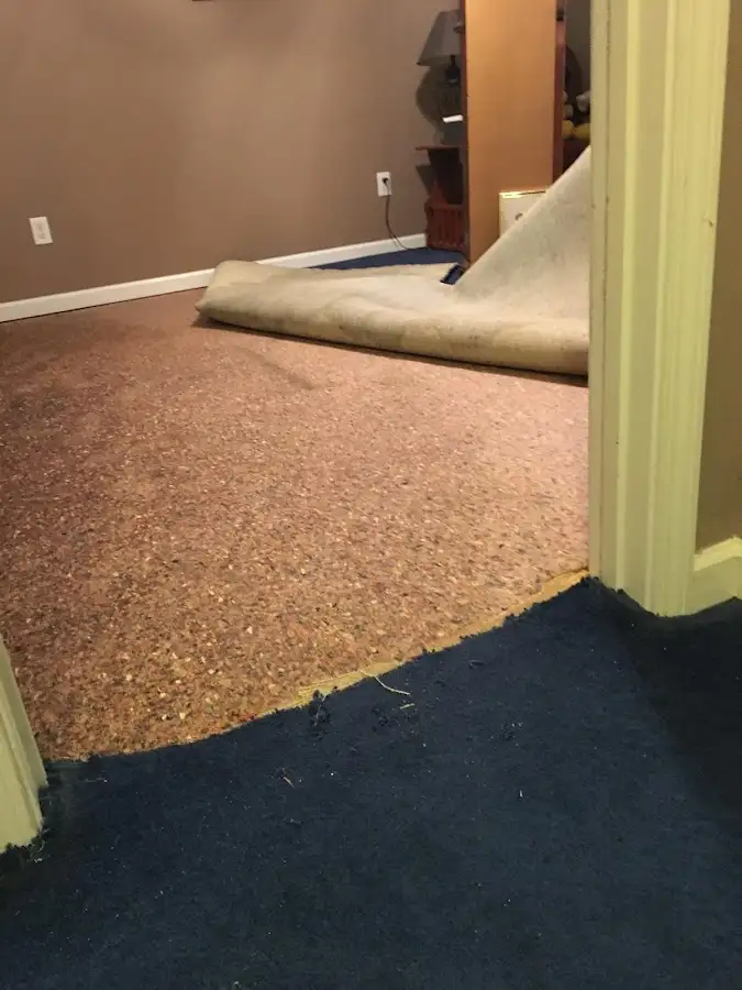 Carpet pad removal revealing water damage during Water Mitigation Services in Bossier City